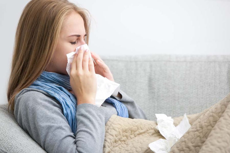 Woman Sneezing.